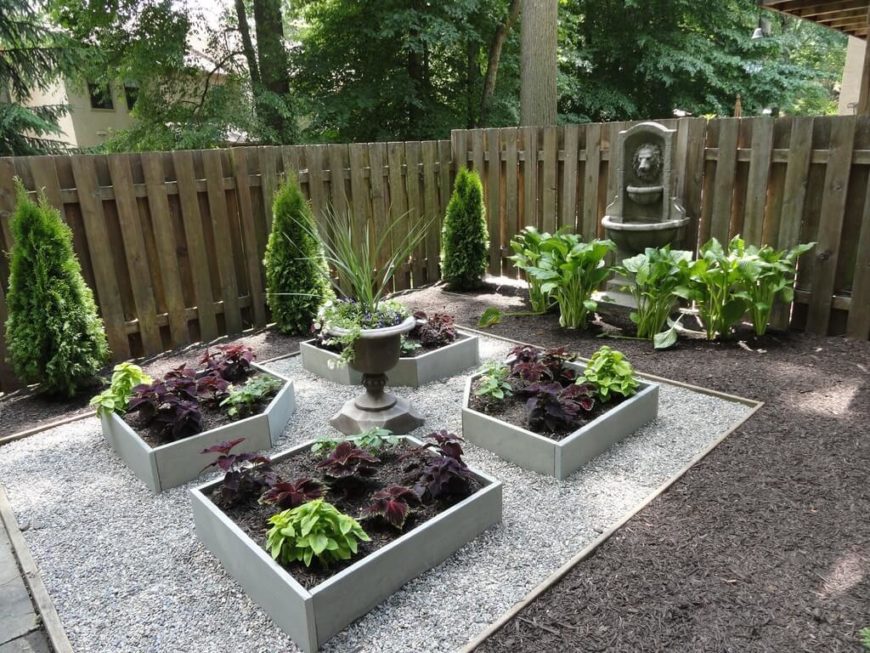 A container garden can even consist of smaller raised planting boxes. This garden is made low-maintenance by removing grass in favor of mulch and pebbles, with a few small planting beds for color. A container garden can even consist of smaller raised planting boxes. This garden is made low-maintenance by removing grass in favor of mulch and pebbles, with a few small planting beds for color.