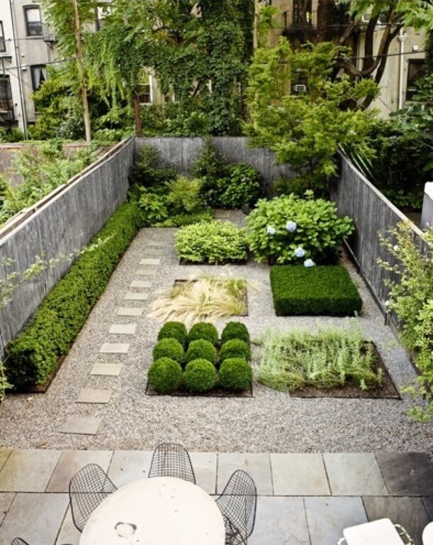 Hedges, topiaries, and other small shrubs are added in small, square sections of this zen garden Hedges, topiaries, and other small shrubs are added in small, square sections of this zen garden