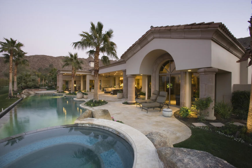 This freeform infinity pool takes up the majority of this home's backyard, but also includes an attached jacuzzi. This freeform infinity pool takes up the majority of this home's backyard, but also includes an attached jacuzzi.