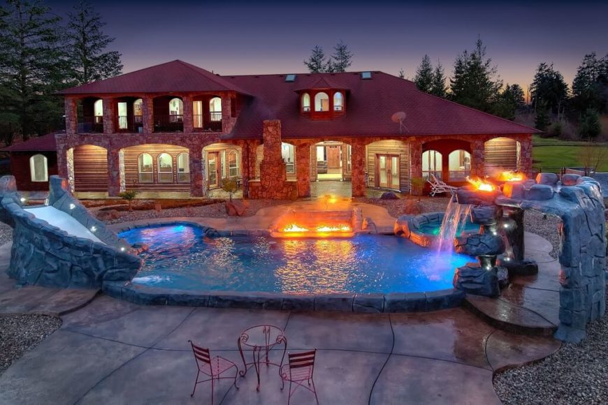 This is a small water park, complete with a faux stone slide, a waterfall with torches and a pathway, and even a hot tub and a small cove. This is a small water park, complete with a faux stone slide, a waterfall with torches and a pathway, and even a hot tub and a small cove.