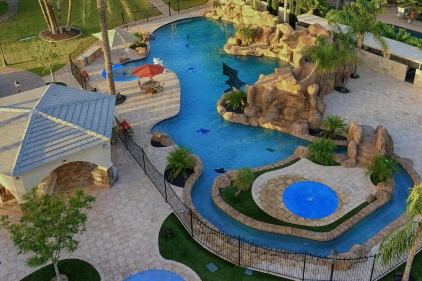 An aerial view allows us to really see this private water park. It has a small lazy river, plenty of coves to play in, and a waterfall along the rocky edge with a slide hidden in those same rocks. An aerial view allows us to really see this private water park. It has a small lazy river, plenty of coves to play in, and a waterfall along the rocky edge with a slide hidden in those same rocks.