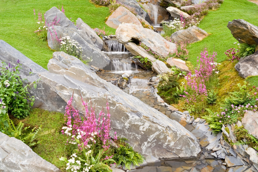 Large diagonal stones, boulders, and stone slabs are positioned over this waterfall, giving it a unique, if somewhat eerie look. Large diagonal stones, boulders, and stone slabs are positioned over this waterfall, giving it a unique, if somewhat eerie look.