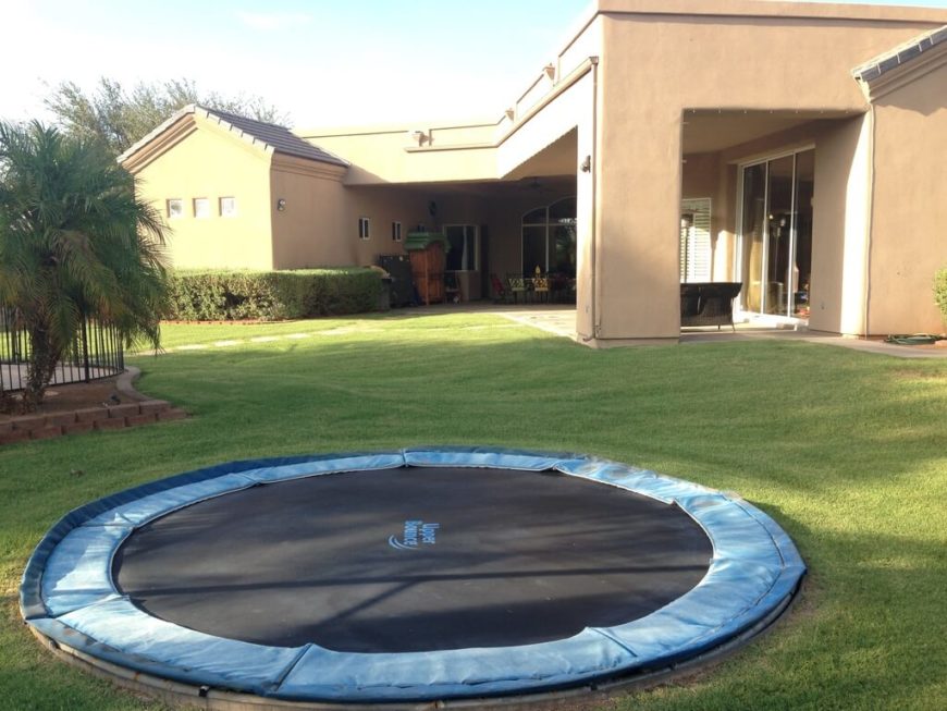 This trampoline has been placed into the ground to eliminate the possibility of a fall This trampoline has been placed into the ground to eliminate the possibility of a fall