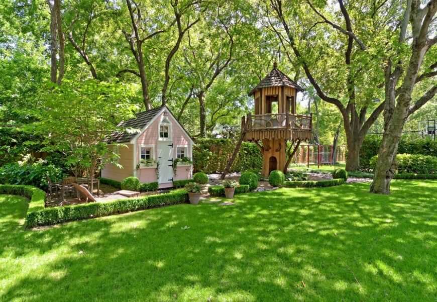 This playground includes a fantasy-style treehouse and a quaint cottage play house. This playground includes a fantasy-style treehouse and a quaint cottage play house.