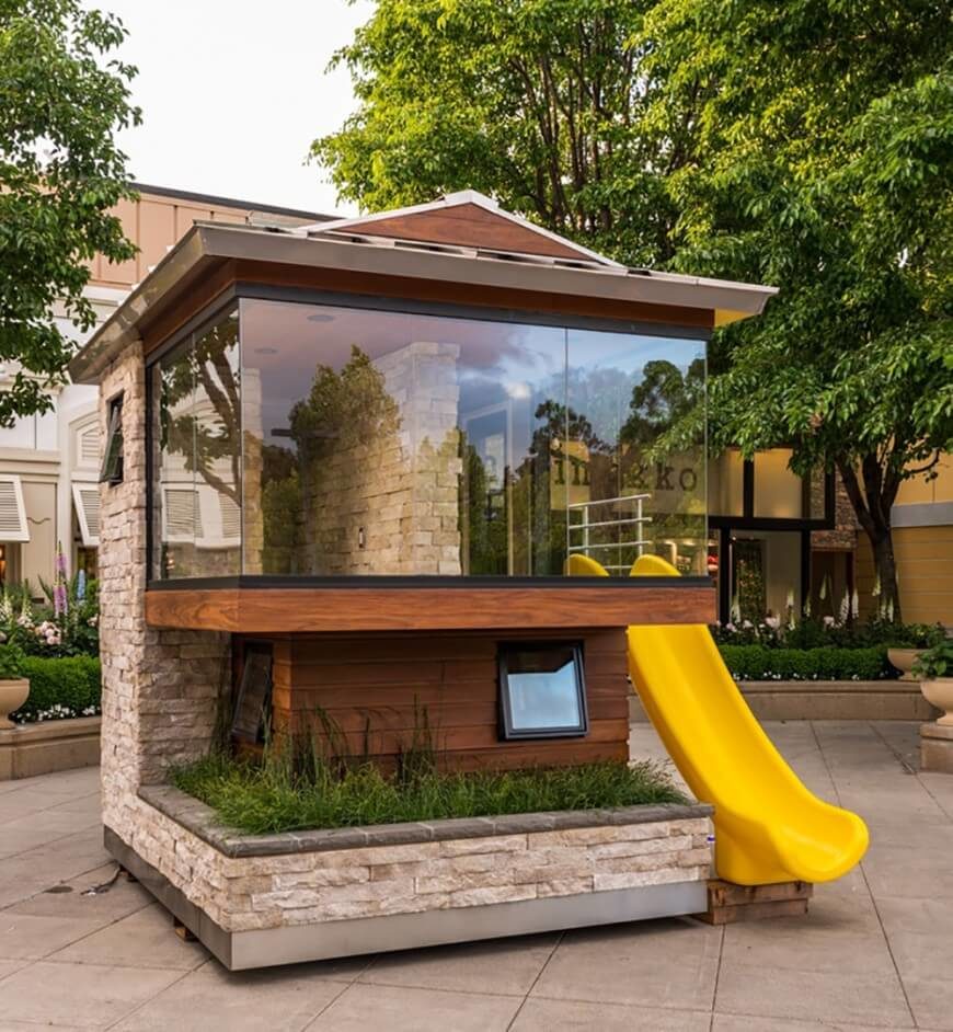 A much more modern playground with a glass window and a slide A much more modern playground with a glass window and a slide