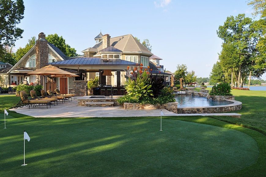 A large putting green placed just beyond the pool and a large patio complete with a covered bar area. A large putting green placed just beyond the pool and a large patio complete with a covered bar area.