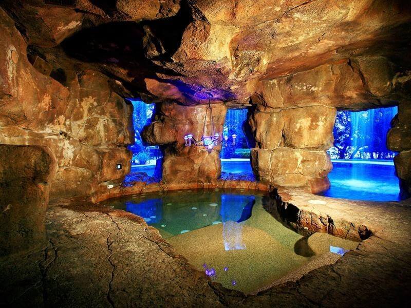 This hot tub is hidden away behind a waterfall in a luxury pool, and has a chandelier! Mom and dad can relax in a secluded cave while the kids hava a ball in the pool! This hot tub is hidden away behind a waterfall in a luxury pool, and has a chandelier! Mom and dad can relax in a secluded cave while the kids hava a ball in the pool!