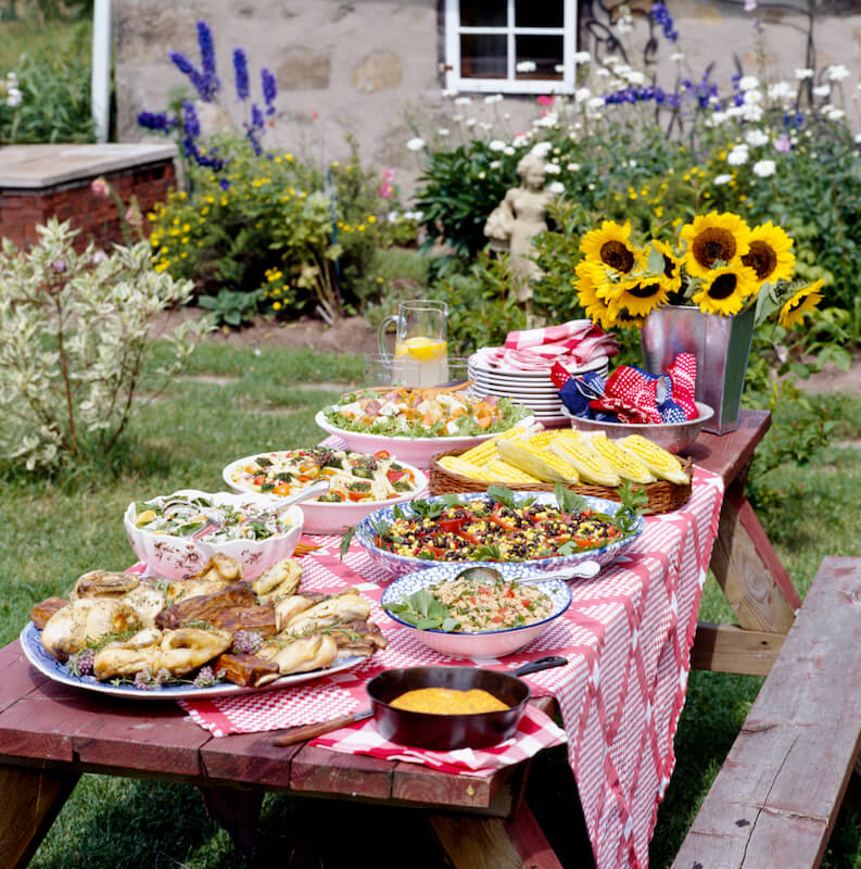 This all wood picnic table is dressed up with a checkered table cloth an loaded with a meal fit for a large family! This all wood picnic table is dressed up with a checkered table cloth an loaded with a meal fit for a large family!