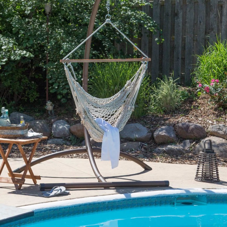 A hammock chair complete with a sturdy stand by the side of the pool. The open weave is perfect for feeling the breeze and drying off after a dip in the pool. A hammock chair complete with a sturdy stand by the side of the pool. The open weave is perfect for feeling the breeze and drying off after a dip in the pool.