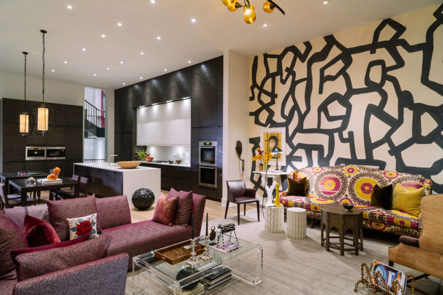 This room has a darker black and off white backdrop for warmer colored furnishings. The room is almost divided by the color theme. One side is covered in a deeper red, while the other has a good splash of yellow. This room has a darker black and off white backdrop for warmer colored furnishings. The room is almost divided by the color theme. One side is covered in a deeper red, while the other has a good splash of yellow.