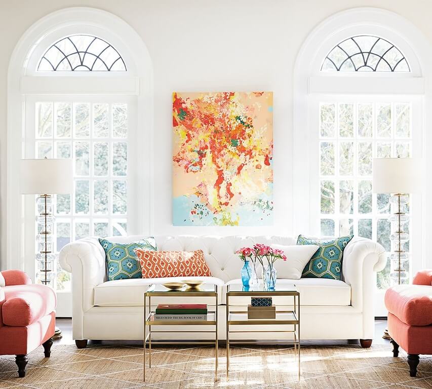 This living room uses an interesting piece of art to pull a color palette. All of the colors that may otherwise not connect to one another, are all together in the painting and then make them all tie together. This living room uses an interesting piece of art to pull a color palette. All of the colors that may otherwise not connect to one another, are all together in the painting and then make them all tie together.