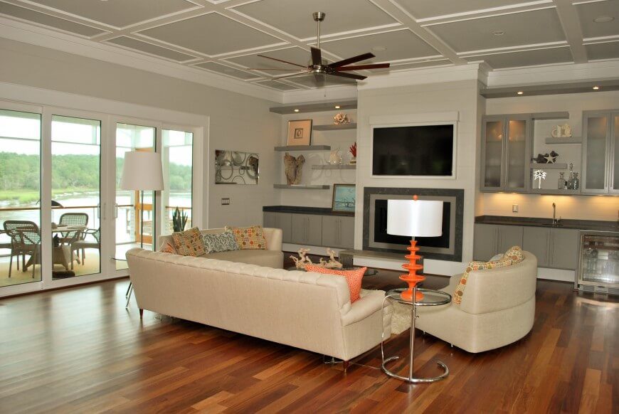 This room features an understated cream palette with orange accents. The orange bring a glowing warmth the creams and off whites, giving a warm lit and cozy illuminated look. This room features an understated cream palette with orange accents. The orange bring a glowing warmth the creams and off whites, giving a warm lit and cozy illuminated look.
