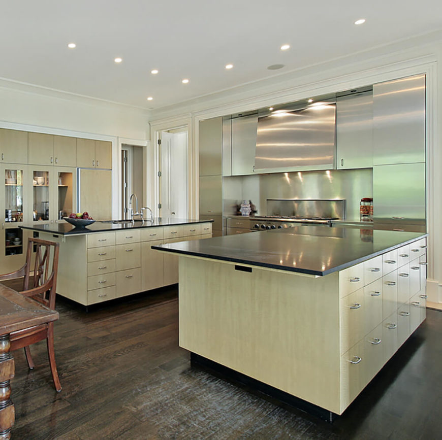 Thin black paper composite countertops on light pine wood cabinetry. What this kitchen lacks in traditional wall cabinet space, it makes up for with dual islands. Thin black paper composite countertops on light pine wood cabinetry. What this kitchen lacks in traditional wall cabinet space, it makes up for with dual islands.