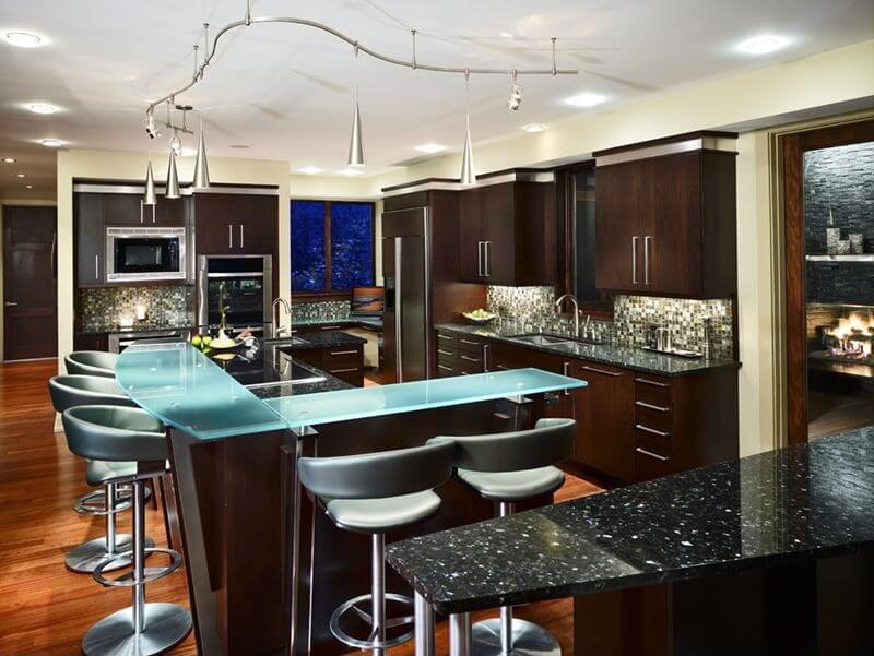 This kitchen features two types of recycled glass countertops, colored and the more traditional black. This kitchen features two types of recycled glass countertops, colored and the more traditional black.