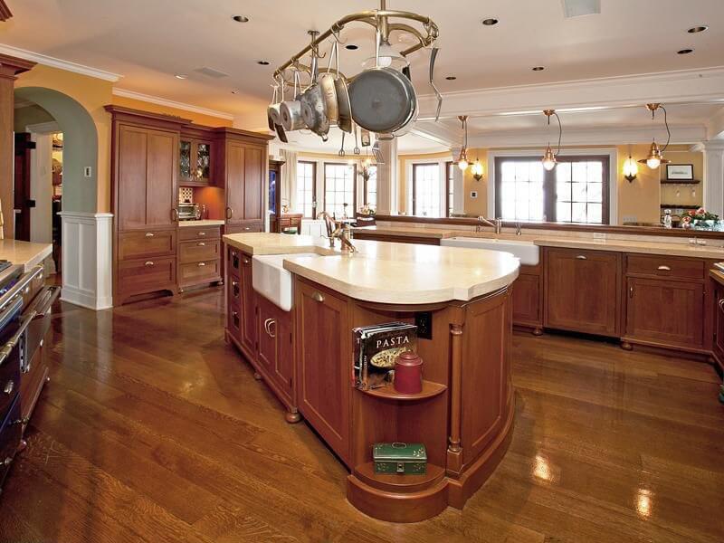 Pale solid surface countertops contrast with the rich wood throughout the rest of the kitchen. Pale solid surface countertops contrast with the rich wood throughout the rest of the kitchen.