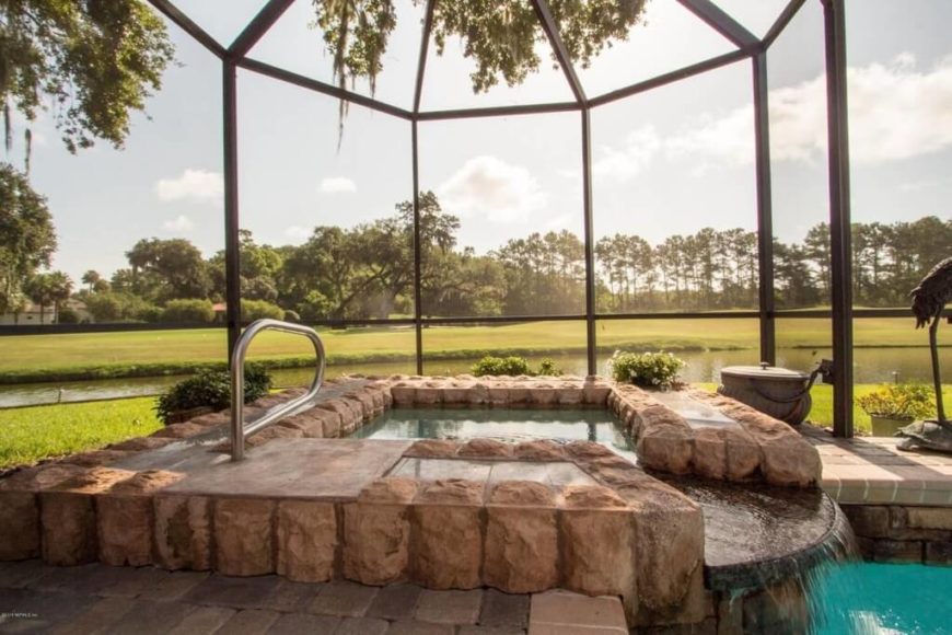 There are lots of ways to incorporate a hot tub into a pool area. A stone edge and a waterfall are great additions that both separates the hot tub into its own section and ties it into the rest of the pool area. There are lots of ways to incorporate a hot tub into a pool area. A stone edge and a waterfall are great additions that both separates the hot tub into its own section and ties it into the rest of the pool area.