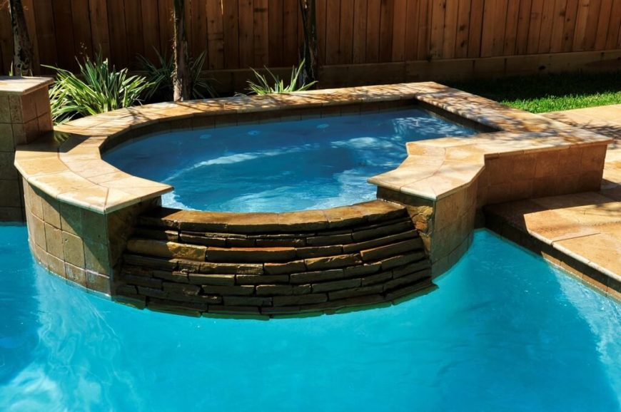 This is a picture of a nice personal hot tub next to a pool. It is so close you could step from one into the other. This is a picture of a nice personal hot tub next to a pool. It is so close you could step from one into the other.