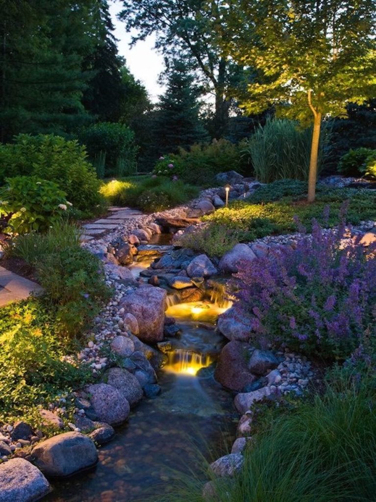 Simple stake lights and well lights can work well together to light your garden from multiple different directions, bringing out the depth of your garden.