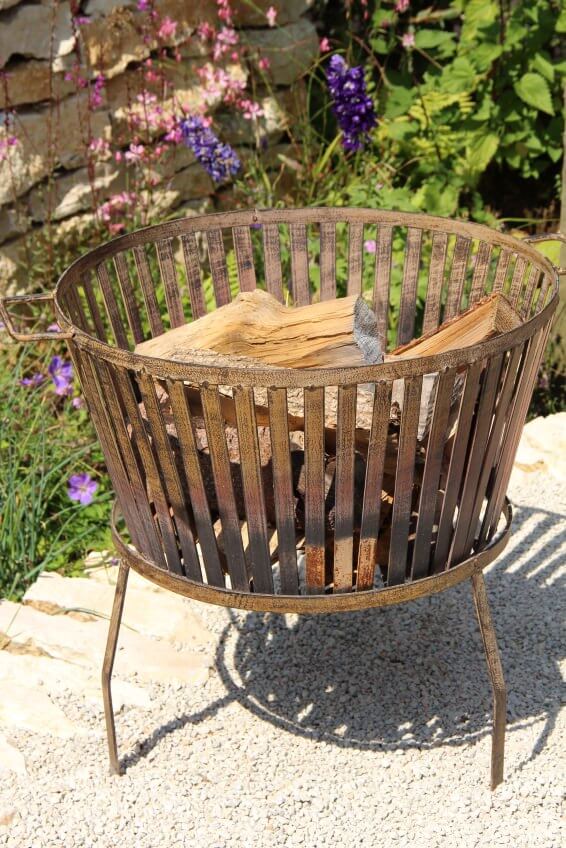 Example of a freestanding metal grate style fire pit that burns wood. This is a very simple fire burning solution for the backyard that can be easily moved. Example of a freestanding metal grate style fire pit that burns wood. This is a very simple fire burning solution for the backyard that can be easily moved.