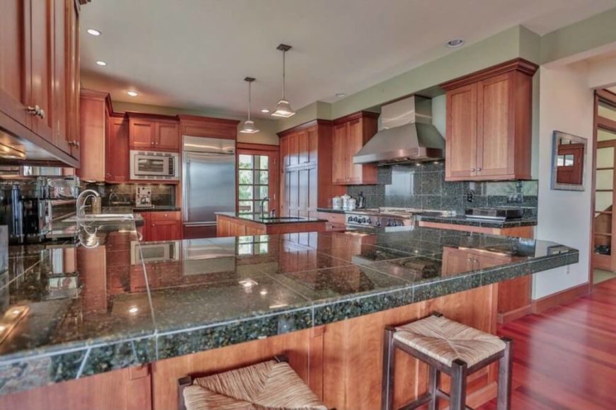 Granite tile countertops are unusual, since slab countertops are more popular overall, but they do fit the theme of a Craftsman kitchen. The simple, beautiful natural wood cabinetry is the most stunning feature of this kitchen design. Granite tile countertops are unusual, since slab countertops are more popular overall, but they do fit the theme of a Craftsman kitchen. The simple, beautiful natural wood cabinetry is the most stunning feature of this kitchen design.