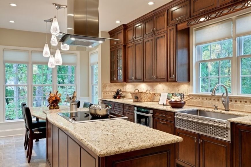 Stainless steel and a darker stain on the cabinets mark this Craftsman kitchen as having a decidedly contemporary inspiration. Stainless steel and a darker stain on the cabinets mark this Craftsman kitchen as having a decidedly contemporary inspiration.