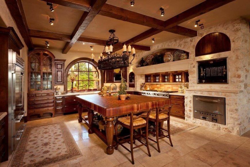 Lots of stone and a few ornate antique pieces show a little Tuscan influence on this kitchen, but the handcrafted furniture and natural materials mark it as Craftsman. Lots of stone and a few ornate antique pieces show a little Tuscan influence on this kitchen, but the handcrafted furniture and natural materials mark it as Craftsman.