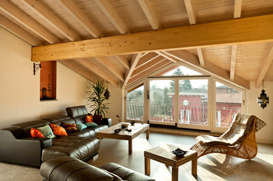 Here, the lighter pine beams support the vaulted roof of this attic family room. Here, the lighter pine beams support the vaulted roof of this attic family room.