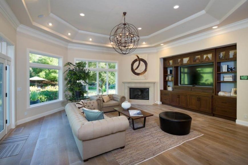 A two-tier tray ceiling gives this spacious family room a bit more height, and serves as a convenient place to create more lighting. A two-tier tray ceiling gives this spacious family room a bit more height, and serves as a convenient place to create more lighting.