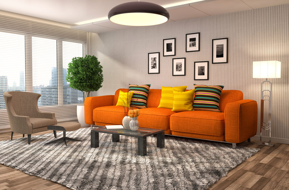 The bright sofa and throw pillows seem so emphasized and highlighted that you might think this was edited in Photoshop. However, nothing has been altered here! It is just the pure power of design and color choice. The designer has done a great job of choosing an orange sofa set along with accented throw pillows and orange tulip blossoms as the centerpiece.