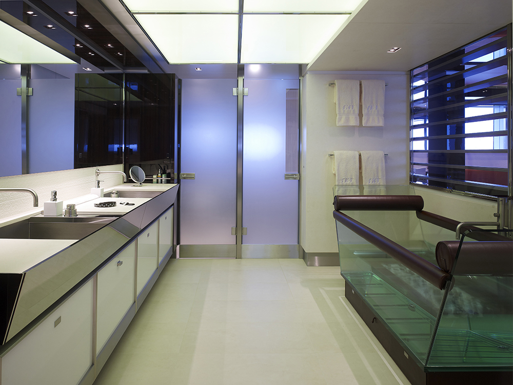 The bathroom is overviewing the suite. Inside is a unique and fab leather and glass bath tub and gleaming surfaces starting from the door and counter steel outlines, extra wide mirrors and bright lighted ceiling. The bathroom is overviewing the suite. Inside is a unique and fab leather and glass bath tub and gleaming surfaces starting from the door and counter steel outlines, extra wide mirrors and bright lighted ceiling.