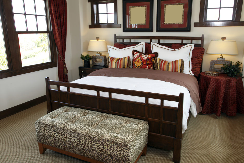 The ottoman (or small loveseat) is a fabulous way to create more usable space and make a primary bedroom seem larger (assuming the room does have enough space for an ottoman or small loveseat at the foot of the bed). The ottoman (or small loveseat) is a fabulous way to create more usable space and make a primary bedroom seem larger (assuming the room does have enough space for an ottoman or small loveseat at the foot of the bed).