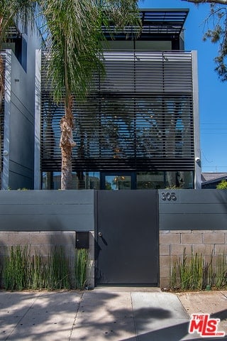 Gated Oasis with Huge Museum-Style Walls, Exposed Steel Beams, and Oversized Windows