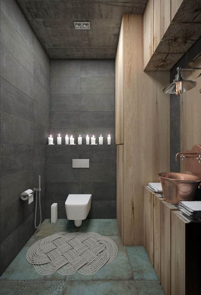This bathroom is a lovely fusion between the industrial-style elements and some farmhouse-style elements. The industrial-style tone of the light green flooring, gray wall and gray concrete ceiling are complemented by the wooden beams of the vanity.