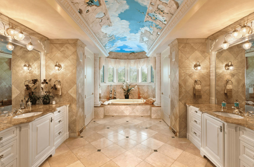 Mediterranean primary bathroom with a stunning sky ceiling and marble tiled flooring arranged in a diamond pattern. It includes facing white sink vanities topped with frameless mirrors.