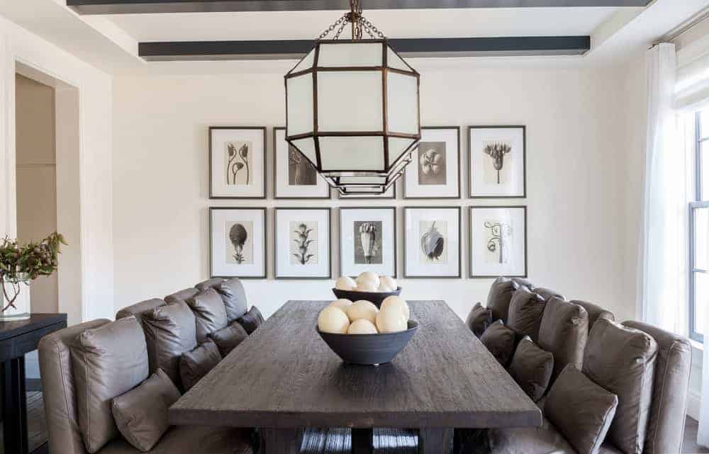 pillows This is a Farmhouse-style dining room with comfortable dining chairs that have brown leather cushions and <a class=
